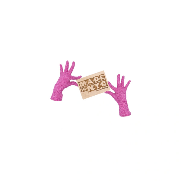 wrist length heathered fuchsia jersey knit gloves holding wooden Made in NYC sign