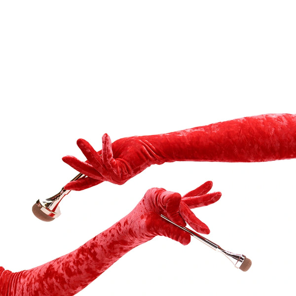 opera length red crushed velour gloves holding makeup brushes