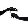 opera length black crushed velour gloves holding makeup brushes