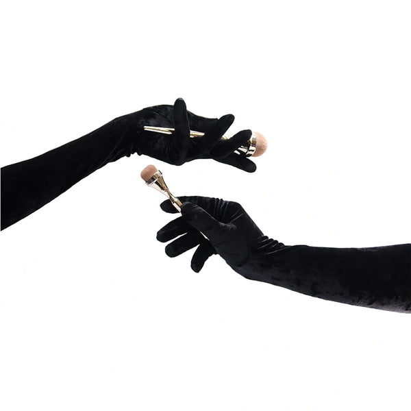 opera length black crushed velour gloves holding makeup brushes