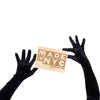 opera length black crushed velour gloves holding wooden Made in NYC sign
