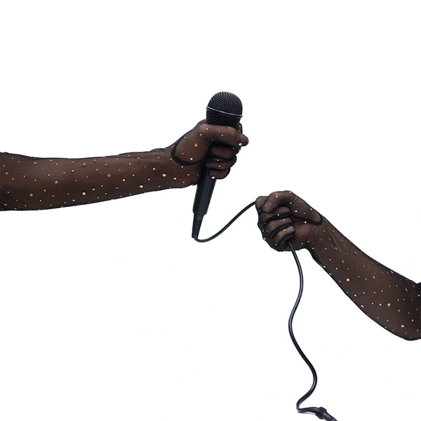 opera length black mesh gloves with gold glittery dots holding a microphone