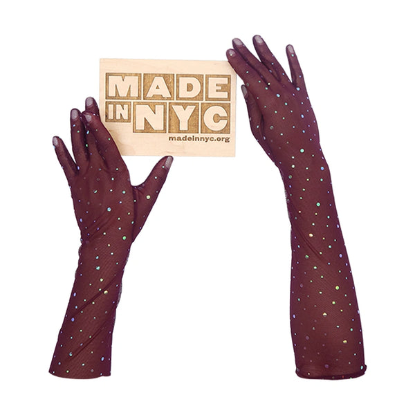 opera length maroon mesh gloves with multicolor glittery dots holding wooden Made in NYC sign