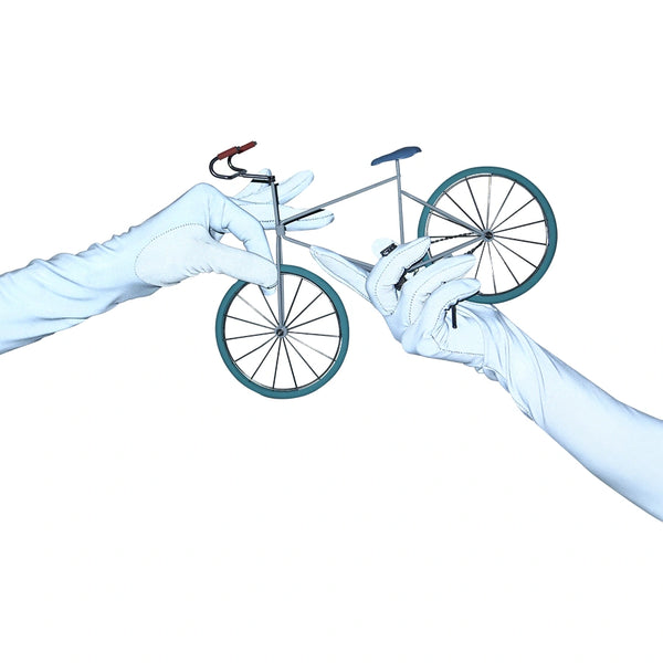 opera length silver reflective vinyl gloves with flash on holding miniature bicycle