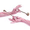 opera length shiny pink vinyl gloves holding makeup brushes