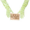 opera length shiny light yellow vinyl gloves holding wooden Made in NYC sign