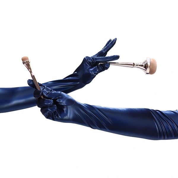 opera length shiny navy vinyl gloves holding makeup brushes