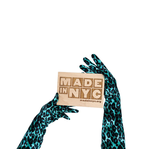 opera length velour jade leopard print gloves holding wooden Made in NYC sign