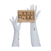 Opera length leather white gloves with three wrist buttons holding a wooden Made in NYC sign