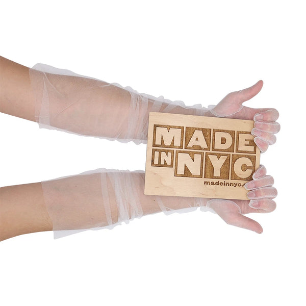 opera length sheer tulle white gloves holding a wooden Made in NYC sign