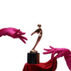 top view of opera length Italian satin fuchsia gloves with a gold trophy on a red tablecloth