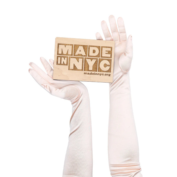opera length satin baby pink gloves holding wooden Made in NYC sign