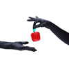 opera length satin black gloves holding an apple