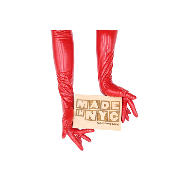 opera length vinyl red gloves holding a wooden Made in NYC sign