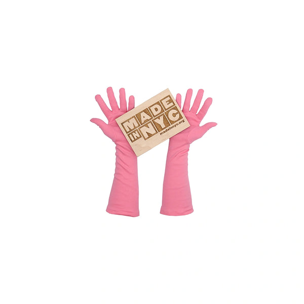 3/4 length pink gloves holding wooden Made in NYC sign