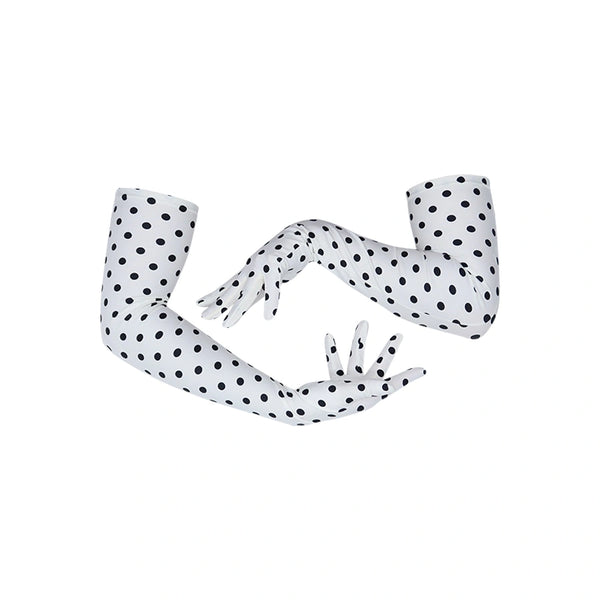 arms posed in long white gloves with small black polka dots