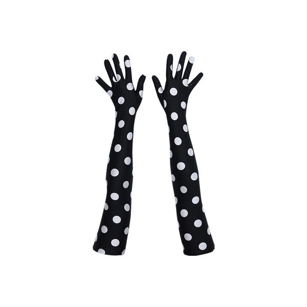 top view of long black gloves with large white polka dots