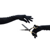 opera length black suede gloves holding scissors in right hand