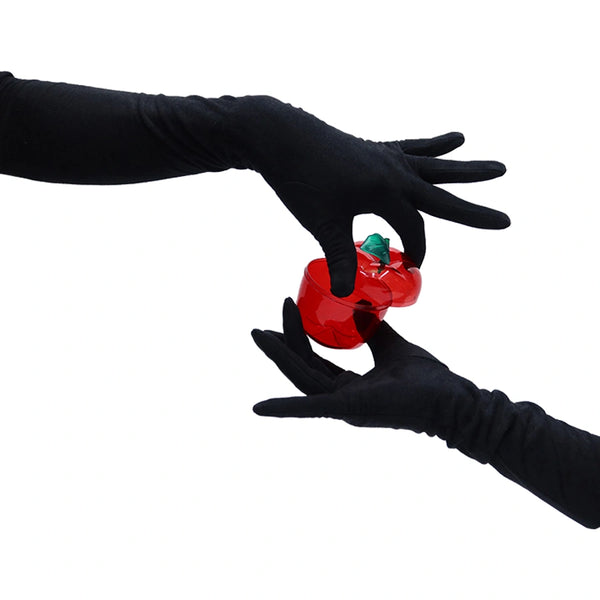 opera length black suede gloves holding a red apple