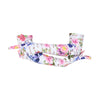long white floral skull pattern gloves with arms crossed holding left arm