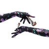 model wearing floral print gloves and holding makeup brushes