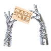 model wearing shiny gold gloves holding a made in nyc sign