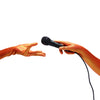 model wearing orange gloves holding a microphone