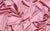 Luxury stretch satin material in a peach color, used for handcrafted gloves