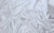 Elegant stretch satin swatch in white, with a lustrous sheen and refined texture for high-end evening gloves