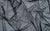 black holographic dot mesh fabric swatch, used for Wing and Weft's gloves