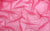 Close-up of pink holo dot stretch mesh fabric, material used for the Michelle gloves, handcrafted in New York’s Garment District