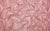 Fabric swatch of Natasha glove’s 4-way stretch holo mini-dot spandex, in a light pink color