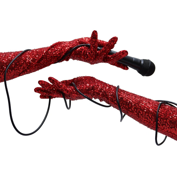 Shiny red sequin fabric on Vera gloves worn by a model, handcrafted in NYC by Wing + Weft
