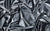 Close-up of black pearlized vinyl fabric, designed for gloves handmade in NYC by Wing + Weft.