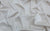 Pearlized white vinyl fabric swatch, used for handmade gloves inspired by Rita Hayworth’s sultry glamour, crafted in NYC by Wing + Weft.