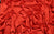 A close-up of red Italian satin fabric swatch, crafted for elegant gloves that channel Sarah Jessica Parker’s fashion icon status.