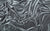 A smooth charcoal gray velour fabric, sleek and modern for stylish gloves.