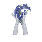 Opera length leather white gloves with three wrist buttonsholding a bouquet of periwinkle larkspurs