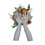 Opera length leather white gloves with three wrist buttons holding an off white rose in front of a flower bouquet