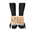 opera length holographic black gloves sewn with crystal claw nails holding Made in NYC sign